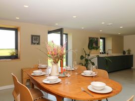 A dining room with a table set for dinner at Reddaway Byre in Okehampton