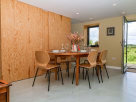 A dining room with a table and chairs at Reddaway Byre Okehampton