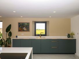 A kitchen with cabinets and a sink at Reddaway Byre Okehampton