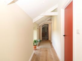 A hallway with a door and a plant at Reddaway Byre Okehampton