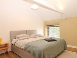 A bedroom with a bed and window at Reddaway Byre Okehampton