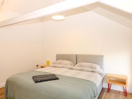 A bedroom with a bed and nightstand at Reddaway Byre in Okehampton
