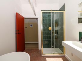 A bathroom with a shower and sink at Reddaway Byre Okehampton