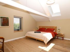 A bedroom with a bed and bedside tables at Reddaway Byre Okehampton