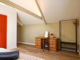 A bedroom with a desk and chair at Reddaway Byre Okehampton