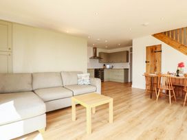 A living room with a sofa and dining table at The Granary in Launceston