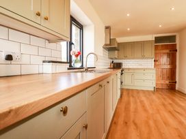 A kitchen with cabinets and a sink at The Granary in Launceston