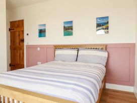 A bedroom with a bed and pictures on the wall at The Granary in Launceston