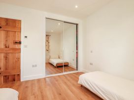 A bedroom with a bed and wardrobe at The Granary in Launceston