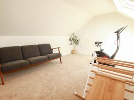 A gym with a sofa and exercise bike at The Granary in Launceston
