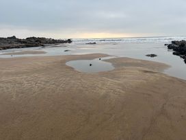 A beach with water and rocks at Up Top in Launceston