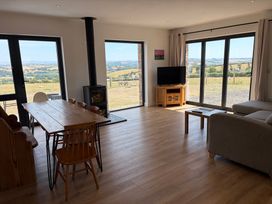 A living room with a table and chairs in High View Barn Launceston