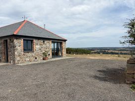 A house with a stone exterior and a gravel area at High View Barn Launceston