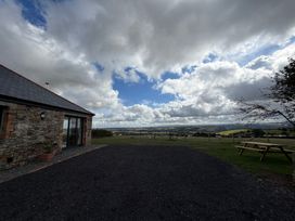 An outdoor view of a stone building with a garden at High View Barn in Launceston