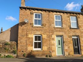 A house exterior with brick wall and windows at Corner House in Wark