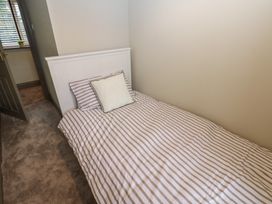 A bedroom with a single bed and a pillow at Corner House in Wark