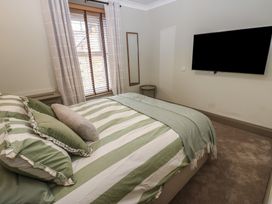 A bedroom with a bed and television at Corner House in Wark