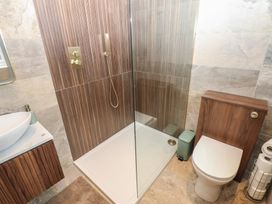 A bathroom with a shower, toilet and sink at Corner House in Wark