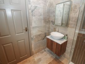 A bathroom with a sink and mirror at Corner House in Wark