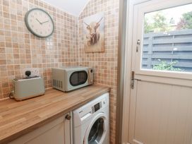 A utility room with appliances at Corner House in Wark