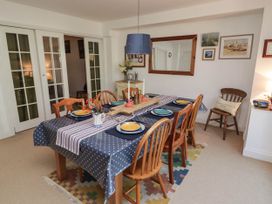 A dining room with a table set for meals at 11b Market Street Narberth
