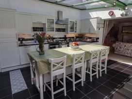 A kitchen with a counter and stools at 11b Market Street Narberth