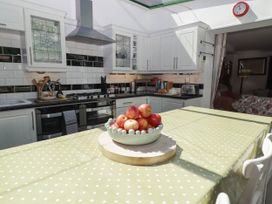 A kitchen with a table and apples at 11b Market Street in Narberth