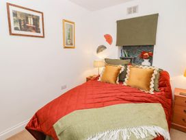 A bedroom with a bed and bedside tables at 11b Market Street Narberth