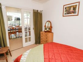 A bedroom with a bed and a dresser at 11b Market Street, Narberth