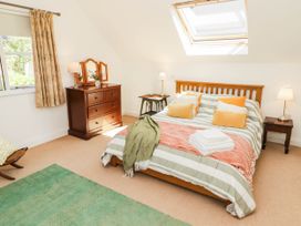 A bedroom with a bed and dresser at 11b Market Street in Narberth