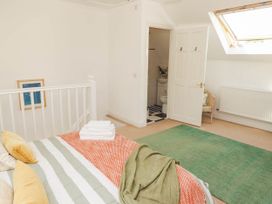 A bedroom with a bed and an ensuite bathroom at 11b Market Street in Narberth