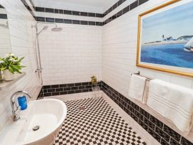 A bathroom with a shower and tub at 11b Market Street in Narberth