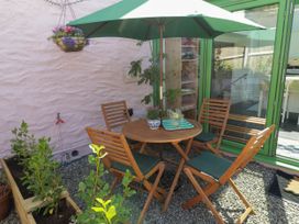 An outdoor seating area with a table and chairs at 11b Market Street Narberth