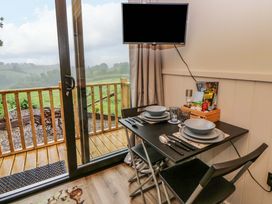A dining area with a table and chairs at The Hut in Llandysul