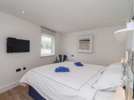 A bedroom with a bed and a television at 5 Sails in Dartmouth