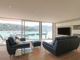 A living room with a view of the harbor at 5 Sails in Dartmouth