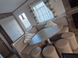 A dining area with a table and seating at Unity Beach in Burnham-on-Sea