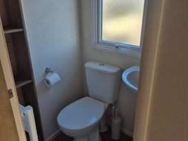 A bathroom with a toilet and sink at Unity Beach - Abi Ryedale Burnham-on-Sea