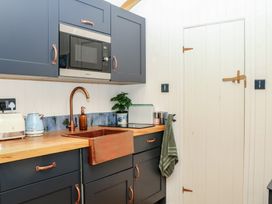 A kitchen with a sink and microwave at Ridden Brake shepherds hut Yelverton