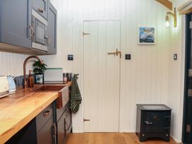 A kitchen with a sink and wooden countertop at Ridden Brake shepherds hut Yelverton