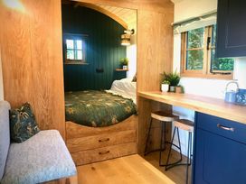 A bedroom featuring a bed and a seating area at Goldcrest in Postbridge