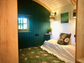 A bedroom with a bed and window at Goldcrest in Postbridge