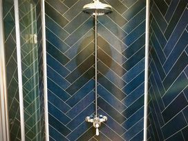A shower with a showerhead and valve at Goldcrest in Postbridge