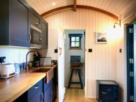 A kitchen with cabinets and appliances at Goldcrest in Postbridge