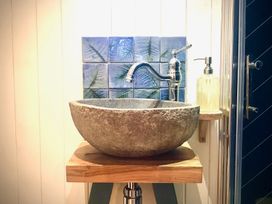 A sink with a stone basin and faucet in a bathroom at Goldcrest in Postbridge