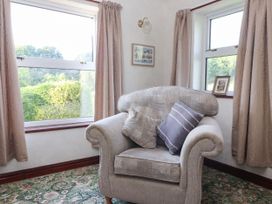 A snug with an armchair and window at Robin Hood Farmhouse in Keswick