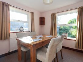 A dining room with a table and chairs at Robin Hood Farmhouse in Keswick