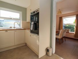 A kitchen with a sink and oven at Robin Hood Farmhouse in Keswick