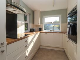 A kitchen with sink, kettle, stove, and oven at Robin Hood Farmhouse in Keswick