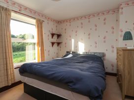 A bedroom with a bed and a window at Robin Hood Farmhouse in Keswick